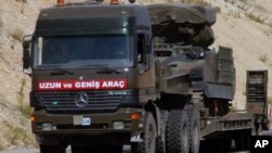 Turkiya harbiy yuk mashinasi raketa uchiruvchi moslamani Suriya chegarasiga keltirmoqda, 28-iyun, 2012-yil.