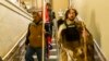 Supporters of President Donald Trump walk down the stairs outside the Senate Chamber as violence erupted at the Capitol following a breach of security, Jan. 6, 2021, in Washington.