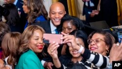 FILE - Maryland Gov. Wes Moore takes a photo with guests at a reception in recognition of Black History Month in the East Room of the White House in Washington, Feb. 6, 2024. 