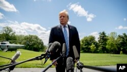FILE - President Donald Trump listens to a question from a member of the media on the South Lawn of the White House in Washington, May 14, 2019.