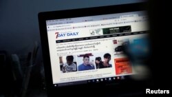 A reporter shows the news about journalists who were detained by Myanmar military, in the Democratic Voice of Burma (DVB) news room in Yangon, June 29, 2017. 