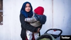 FILE - Hoda Muthana holds her son in this undated photo.