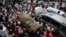FILE - Relatives carry the body of 13-year-old Yassin Moyo for burial, at the Kariakor cemetery in Nairobi, Kenya, March 31, 2020. Police in the capital are accused of shooting him dead while enforcing a coronavirus curfew.