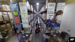Pallets of various foods are stacked on shelves in the extensive warehouse at the Houston Food Bank Wednesday, Oct. 14, 2020, in Houston. (AP Photo/Michael Wyke)