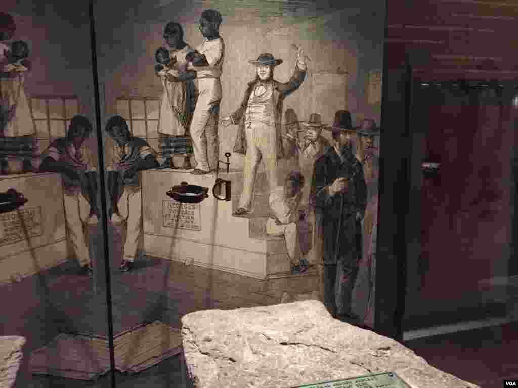 A stone slave auction block from Hagerstown, Maryland, is displayed at the Smithsonian National Museum of African American History & Culture in Washington, D.C. (C. Simkins/VOA)