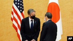 Japanese Prime Minister Yoshihide Suga, right, meets with US Secretary of State Antony Blinken during a courtesy call at the prime minister's official residence, March 16, 2021.