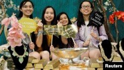 Attendees at a booth promoting the new movie "Crazy Rich Asians" as they participate at KCON USA, billed as the world's largest Korean culture convention and music festival, in Los Angeles, California, Aug. 10, 2018.