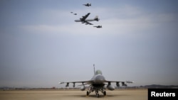 A U.S. Air Force B-52 flies over Osan Air Base in Pyeongtaek, South Korea, Jan. 10, 2016. 