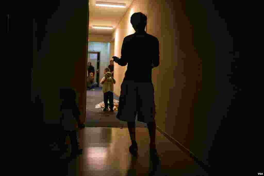 Children play in the corridors leading to their rooms. The rooms come with en-suite shower and toilet - a stark contrast to the conditions many were living in before they arrived here. (J. Owens/VOA)