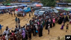 Newly arrived Rohingya refugees stand in a line to receive food rations in Kutupalong, Bangladesh, Sept. 30, 2017. As of Thursday, U.N. deputy spokesman Farhan Haq said, the U.N. and its humanitarian partners have received $36.4 million — just under half of the $77 million that the U.N. called for in early September to address the Rohingya crisis. 