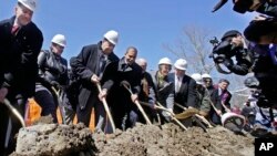 FILE - Taunton Mayor Thomas Hoye, far left, Tribal Chairman Cedric Cromwell, third from left, and others wield shovels during an official casino groundbreaking, April 5, 2016, in Taunton, Mass. (AP Photo/Elise Amendola)