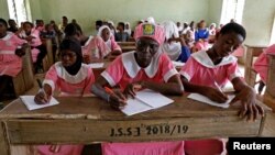 Shade Ajayi, 50, takes notes during class at Ilorin Grammar School in Ilorin, Kwara state, March 25, 2021. R