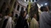 Christian clergy and worshipers hold palm fronds during a procession in the Church of the Holy Sepulcher in Jerusalem's Old City March 24, 2013.