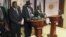 South Sudan President Salva Kiir (C), flanked by former rebel leader Riek Machar (L) and other government officials, addresses a news conference at the Presidential State House in Juba, South Sudan, July 8, 2016. 