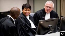 FILE - Prosecutor Fatou Bensouda (C) and Deputy Prosecutor James Stewart (R) attend the first audience with the chief of Central African Republic's soccer federation Patrice-Edouard Ngaissona at the International Criminal Court (ICC) in The Hague, the Netherlands, Jan. 25, 2019. 
