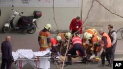 In this image made from video, emergency rescue workers stretcher an unidentified person at the site of an explosion at a metro station in Brussels, Belgium. 