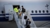 Members of an aid expedition in protective masks disembark from Air China plane carrying medical supplies donated by the Chinese government, in Athens, Greece, March 21, 2020.