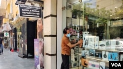 Shutters are lifted and shops spruced up as Delhi's markets open after two months as lockdown restrictions are eased. (Anjana Pasricha/VOA)