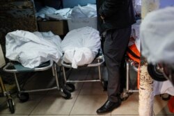 FILE - Pat Marmo, owner of Daniel J. Schaefer Funeral Home, walks through his body holding facility that is struggling to handle overflow of clients stemming from COVID-19 deaths, April 2, 2020, in the Brooklyn borough of New York.