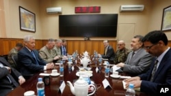 U.S. Secretary of Defense Chuck Hagel, left, meets with Afghanistan's Defense Minister Bismallah Khan Mohammadi, second right, at the ISAF (International Security Assistance Force) headquarters in Kabul, March 10, 2013.