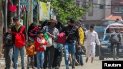 People flee the eastern parts of Rafah after the Israeli military began evacuating Palestinian civilians ahead of a threatened assault on the southern Gazan city