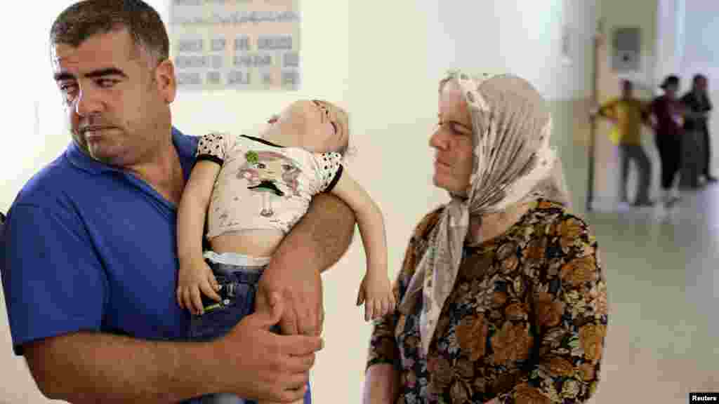 Iraqi Christians, who fled violence brought by Islamic State militants in the village of Qaraqosh, seek refuge inside a church building in Irbil, north of Baghdad, Aug. 11, 2014.