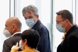 Laurent Sourisseau, chief editor of satirical magazine Charlie Hebdo, leaves the courtroom during a break on the opening day of the trial of the 2015 Paris attacks, at Paris courthouse, France, Sept. 2, 2020.