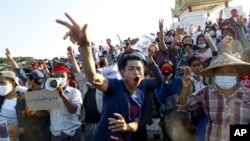 Demonstrators flash a three-fingered symbol of resistance against the military coup and shout slogans calling for the release of detained Myanmar leader Aung San Suu Kyi during a protest in Mandalay, Myanmar on Feb. 10, 2021.
