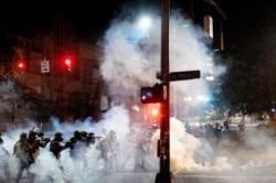 Federal agents use crowd control munitions to disperse Black Lives Matter protesters near the Mark O. Hatfield United States Courthouse, July 20, 2020, in Portland, Ore.