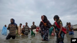 In this July 26, 2019 photo, Ethiopian migrants disembark from a boat onto the shores of Ras al-Ara, Lahj, Yemen. Funded by the European Union, Ethiopia has cracked down on migrant smugglers and intensified border controls. Arrests of known brokers…
