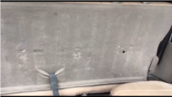 A bullet hole in the back seat of Deputy Printemps Belizaire’s Toyota SUV.