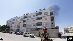 Rebel fighters secure a largely abandoned residential area during fighting in Abu Slim in Tripoli August 25, 2011
