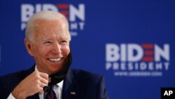 Democratic presidential candidate former Vice President Joe Biden smiles while speaking during a roundtable on economic reopening with community members, June 11, 2020, in Philadelphia. 