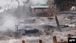 FILE - This handout photo from Pauk Township News taken and released June 16, 2021, shows the remains of houses allegedly set on fire by Myanmar junta forces, in Kin Ma village, Pauk township, in Myanmar's Magway region.