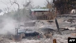 FILE - This handout photo from Pauk Township News taken and released June 16, 2021, shows the remains of houses allegedly set on fire by Myanmar junta forces, in Kin Ma village, Pauk township, in Myanmar's Magway region.