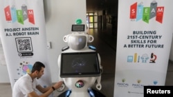 High school student Konstantinos Timinis works on "Alnstein", a robot powered with ChatGPT, in Pascal school in Nicosia, Cyprus on March 30, 2023. (REUTERS/Yiannis Kourtoglou)