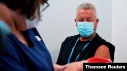 The Pfizer COVID-19 vaccine is prepared for a high-risk worker in Melbourne, May 12, 2021.