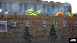 FILE - Iraqi security forces stand guard in front of the U.S. Embassy in the capital Baghdad, Jan. 1, 2020.