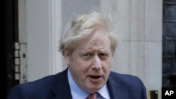 FILE - In this Wednesday, March 25, 2020 file photo Britain's Prime Minister Boris Johnson leaves 10 Downing Street for the House of Commons for his weekly Prime Ministers Questions, in London.(AP Photo/Matt Dunham, File)