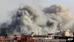Smoke plumes rise over Gaza City on Oct. 7, 2023, during Israeli air strikes following a major attack on Israel by Hamas.