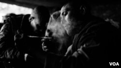 A man resting under the bridge in Pul a Sukhta among a large group of other drug users. (Maciej Stanik/VOA)