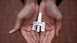 FILE - In this Jan. 23, 2018, file photo, Leah Hill, a behavioral health fellow with the Baltimore City Health Department, displays a sample of Narcan nasal spray in Baltimore, Maryland. The drug is a critical tool to easing America's opioid crisis. (AP Photo/Patrick Semansky)