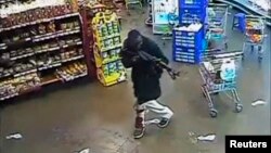 Gunman aims rifle inside store during attack on Westgate shopping mall, Nairobi, Sept. 2013.