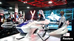 Un participant regarde une voiture volante SkyDrive à émission zéro lors du CES 2022 à Las Vegas, Nevada, États-Unis, le 6 janvier 2022. 