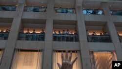 A protester gestures with five fingers, signifying the "Five demands - not one less" in a shopping mall during a protest against China's national security legislation for the city, in Hong Kong, June 1, 2020. 