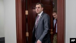 FILE - This March 28, 2017, file photo shows Rep. Justin Amash, R-Mich., followed by Rep. Jim Jordan, R-Ohio, leaving a closed-door strategy session on Capitol Hill in Washington.