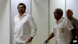 FILE - Ivan Marquez, chief negotiator for the Revolutionary Armed Forces of Colombia, or FARC, left, is seen arriving for a new round of peace talks with Colombia's government in Havana, Cuba, June 17, 2015.