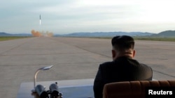 FILE - North Korean leader Kim Jong Un watches the launch of a Hwasong-12 missile in this undated photo released by North Korea's Korean Central News Agency, Sept. 16, 2017.