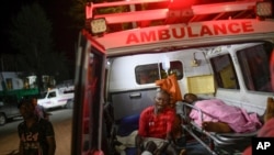 Injured people sit in the ambulance that transferred them from another town to the Immaculee Conception hospital in Les Cayes, Haiti, Aug. 17, 2021, three days after an earthquake struck the southwestern part of the nation.