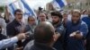 Israeli right-wing activists confront a security official near the Western Wall inside the old city of Jerusalem, Oct. 30, 2014. 